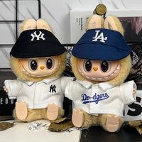Labubu wearing New York Yankees and Los Angeles Dodgers hats and jerseys.